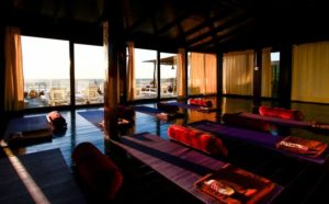 Villa Mandala's yoga shala with big windows and mats laid out